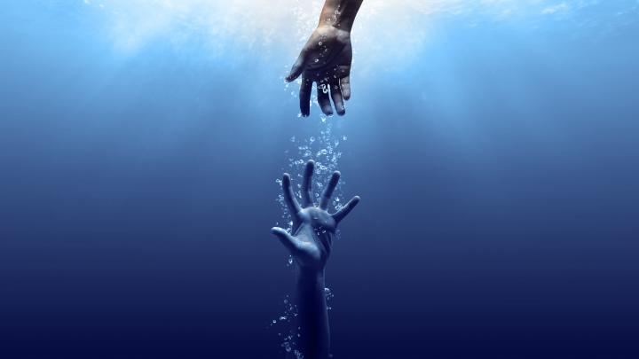 arm reaching down to help drowning person