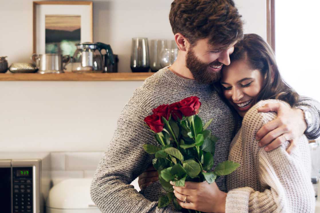 on wanting more - happy couple, man giving flowers to woman, hugging