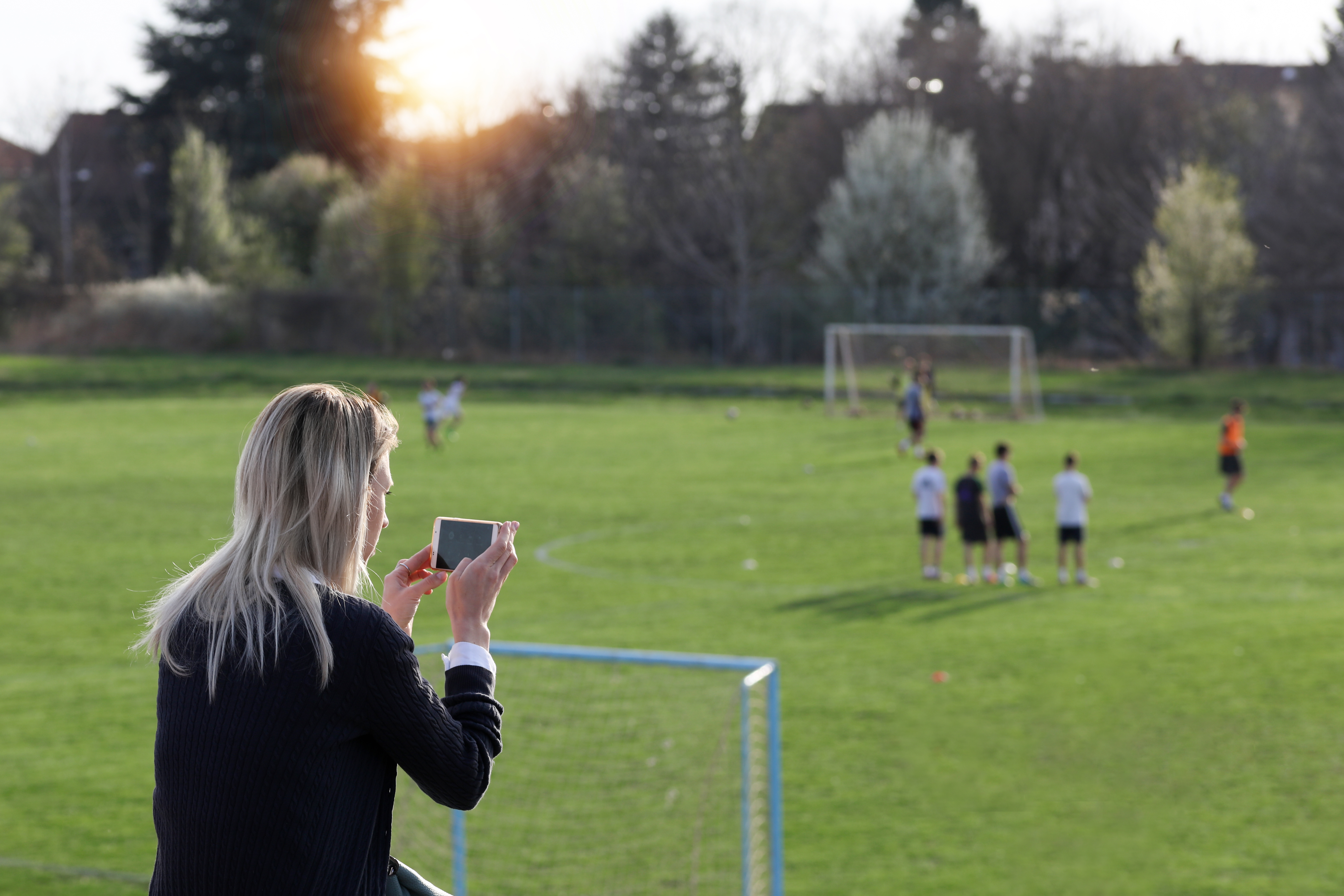 Mom taking photo of kids game