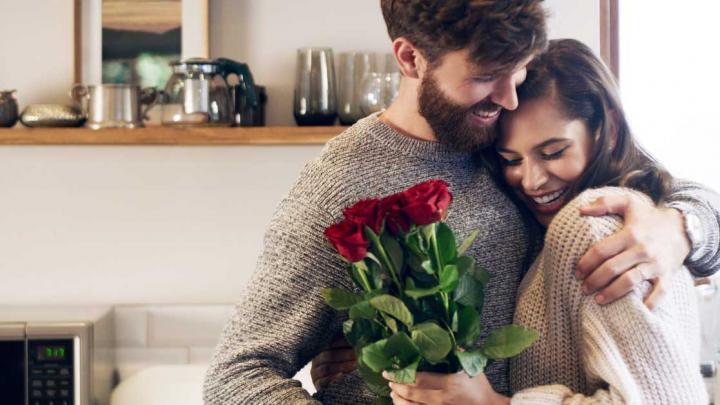 on wanting more - happy couple, man giving flowers to woman, hugging