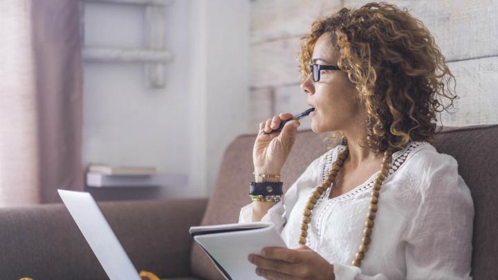 woman thinking writing typing working