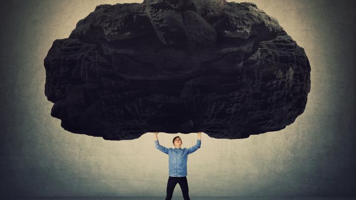 man carrying boulder