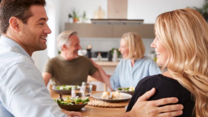 Introducing Boyfriend Or Girlfriend To Senior Parents At Meal Around Table At Home Together