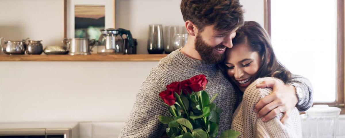 on wanting more - happy couple, man giving flowers to woman, hugging