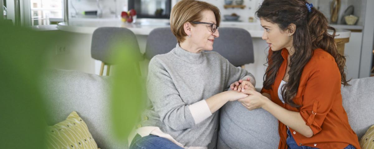 Mother daughter talking on couch