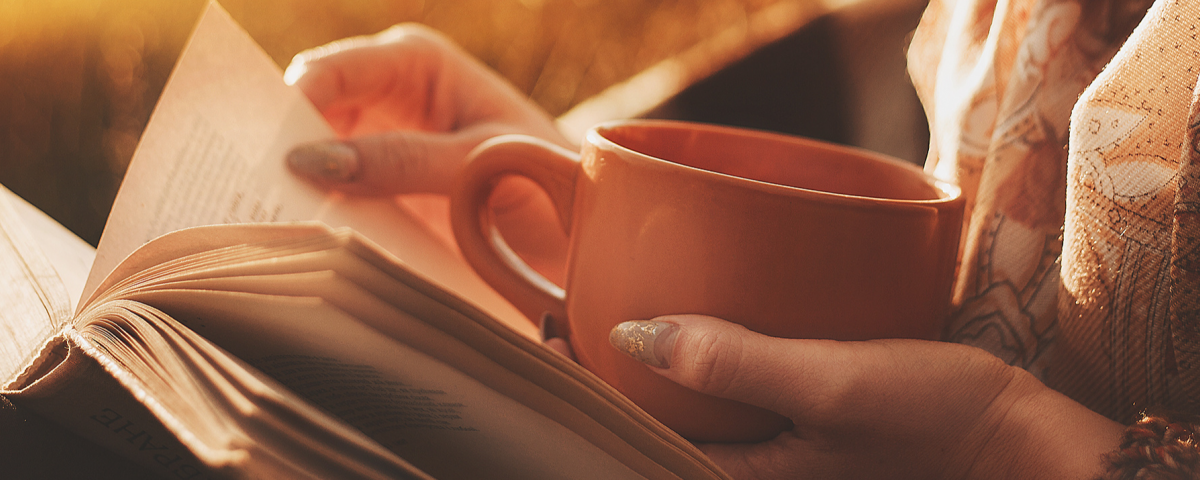 Woman Reading with cup of coffee