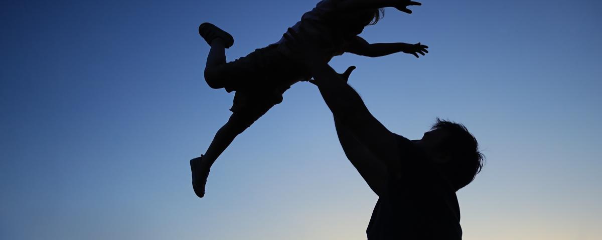 father and child playing silhouette