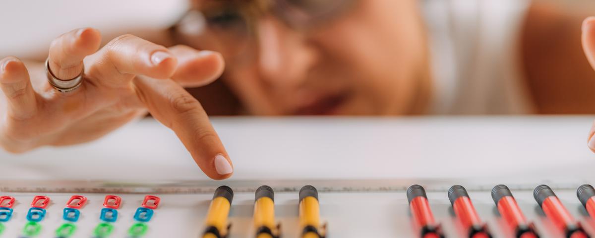 woman aligning pencils