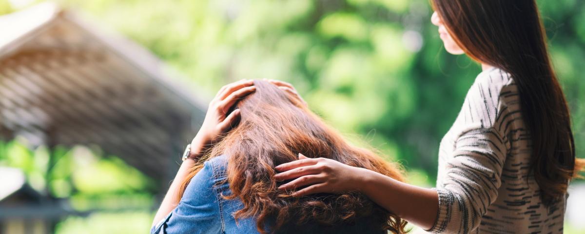 A woman comforting and giving encouragement to her sad friend