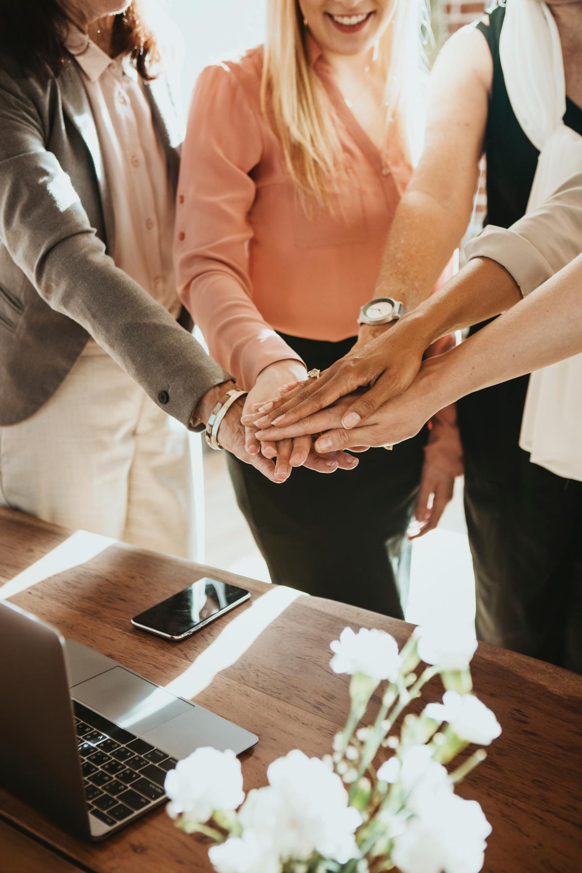 Team of business people stacking hands